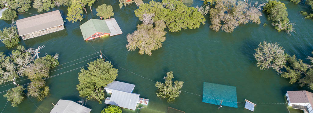 Aerial view of a flooded residential area with houses - www.compassinsurancegroup.com
